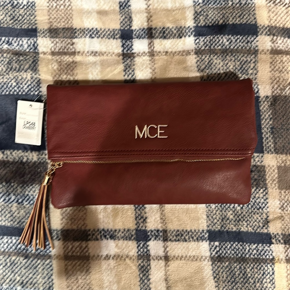 Cranberry clutch. Snap closure. Brand new, never used. Original tag
